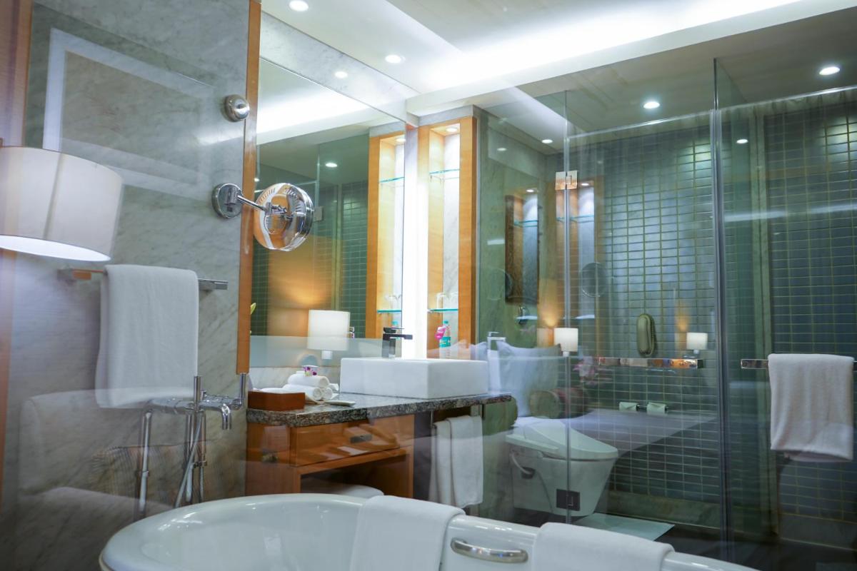 a bathroom with a sink and a toilet and a shower at Crowne Plaza Today Gurugram by IHG in Gurgaon