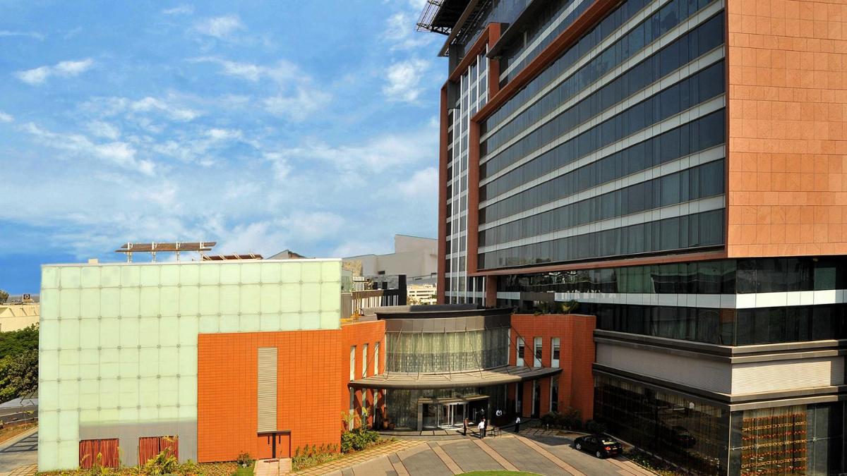 a view of a city with two tall buildings at The Oterra in Bengaluru