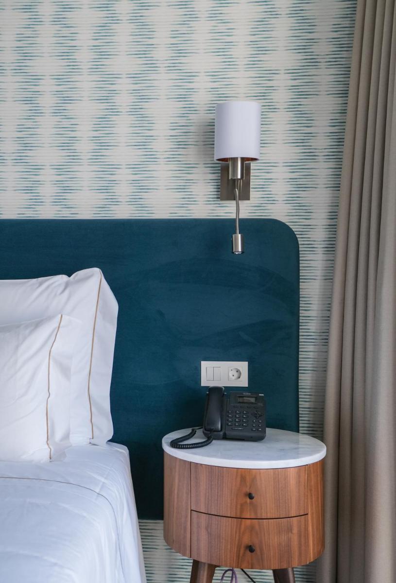 Uma cama ou camas num quarto em Hotel Vouga