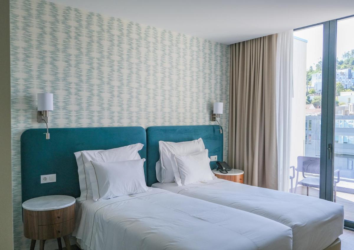 Uma cama ou camas num quarto em Hotel Vouga