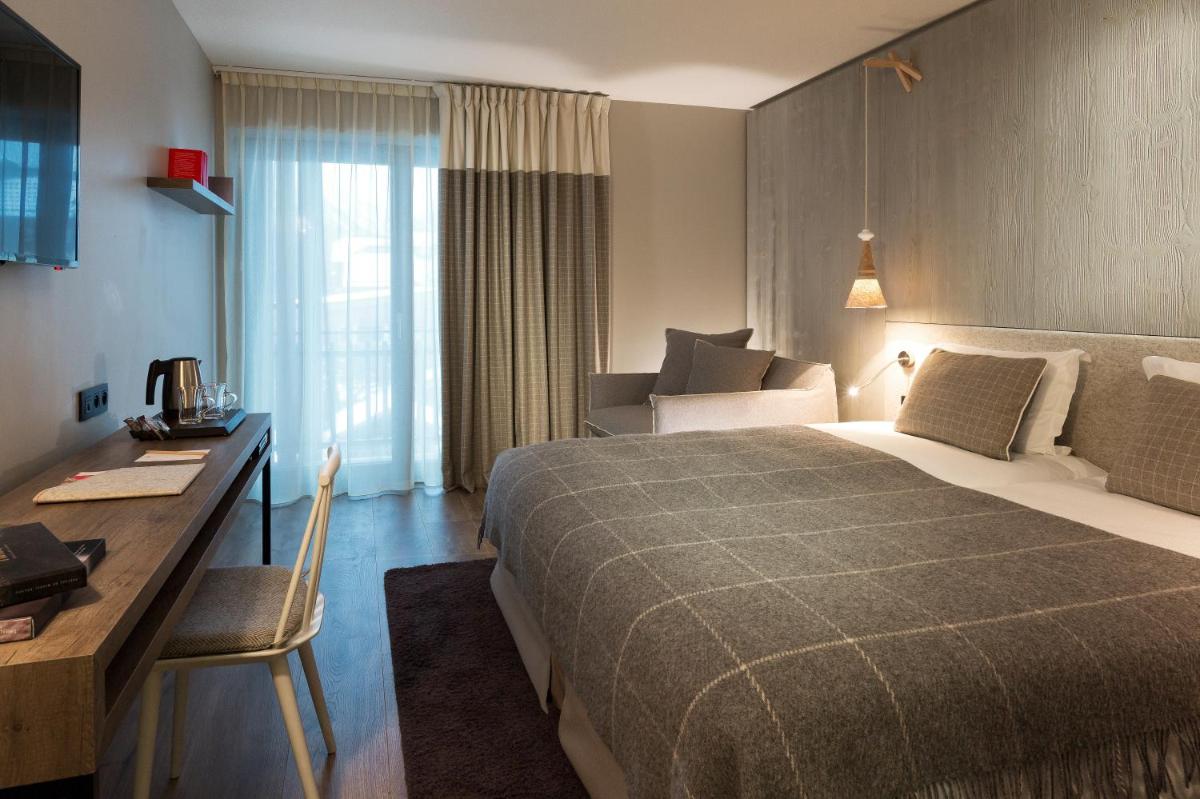 Un ou plusieurs lits dans un hébergement de l'établissement Heliopic Hotel & Spa