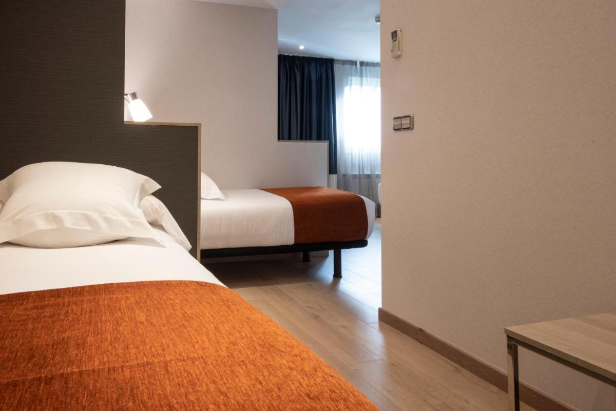 Cama o camas de una habitación en Hotel Avenida