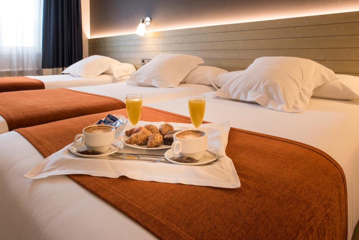 Cama o camas de una habitación en Hotel Avenida