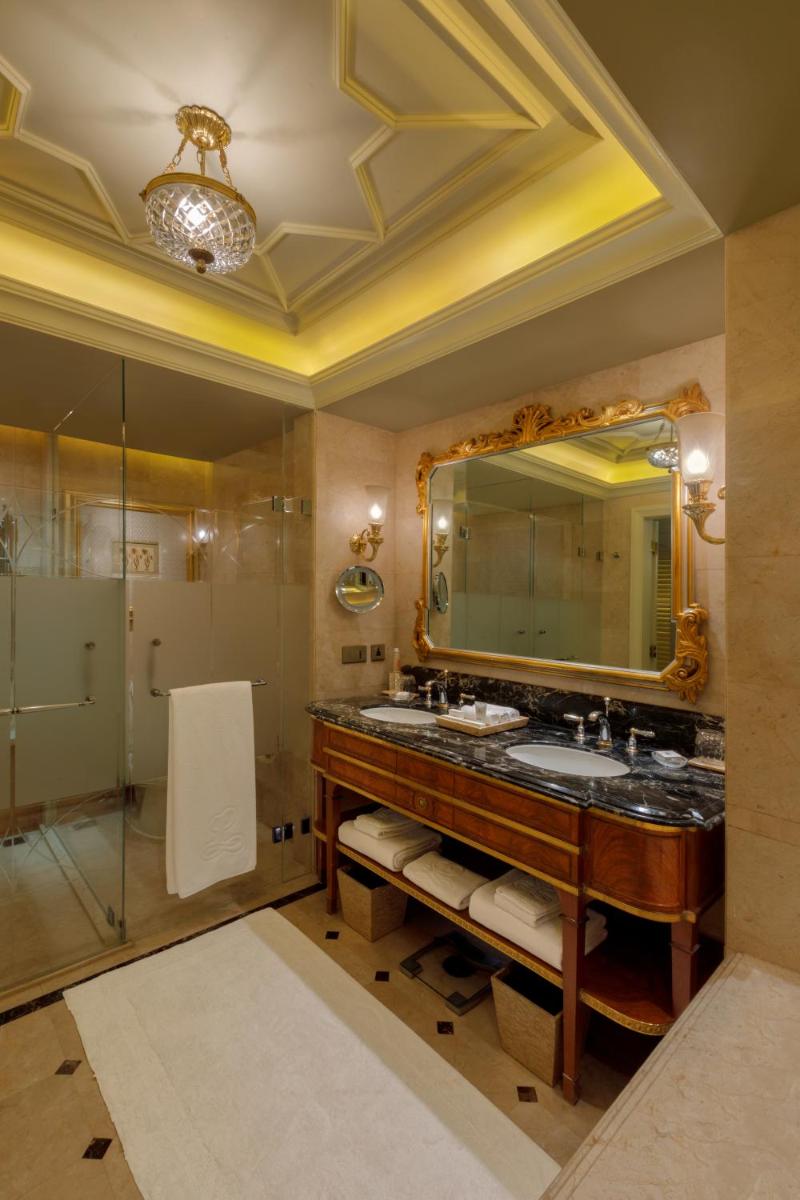 a bathroom with two sinks and a large mirror at The Leela Palace New Delhi in New Delhi a bathroom with two sinks and a large mirror at The Leela Palace New Delhi in New Delhi