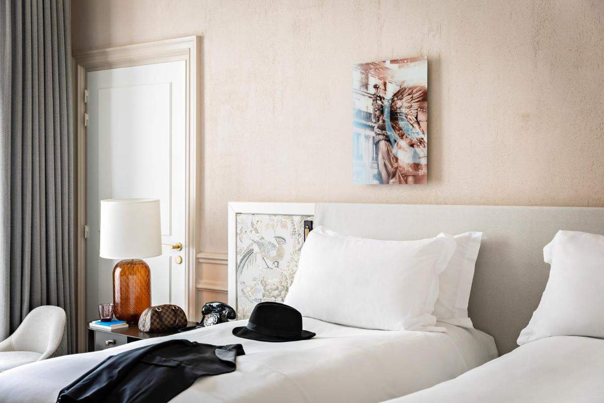 Un ou plusieurs lits dans un hébergement de l'établissement Sofitel Le Scribe Paris Opera
