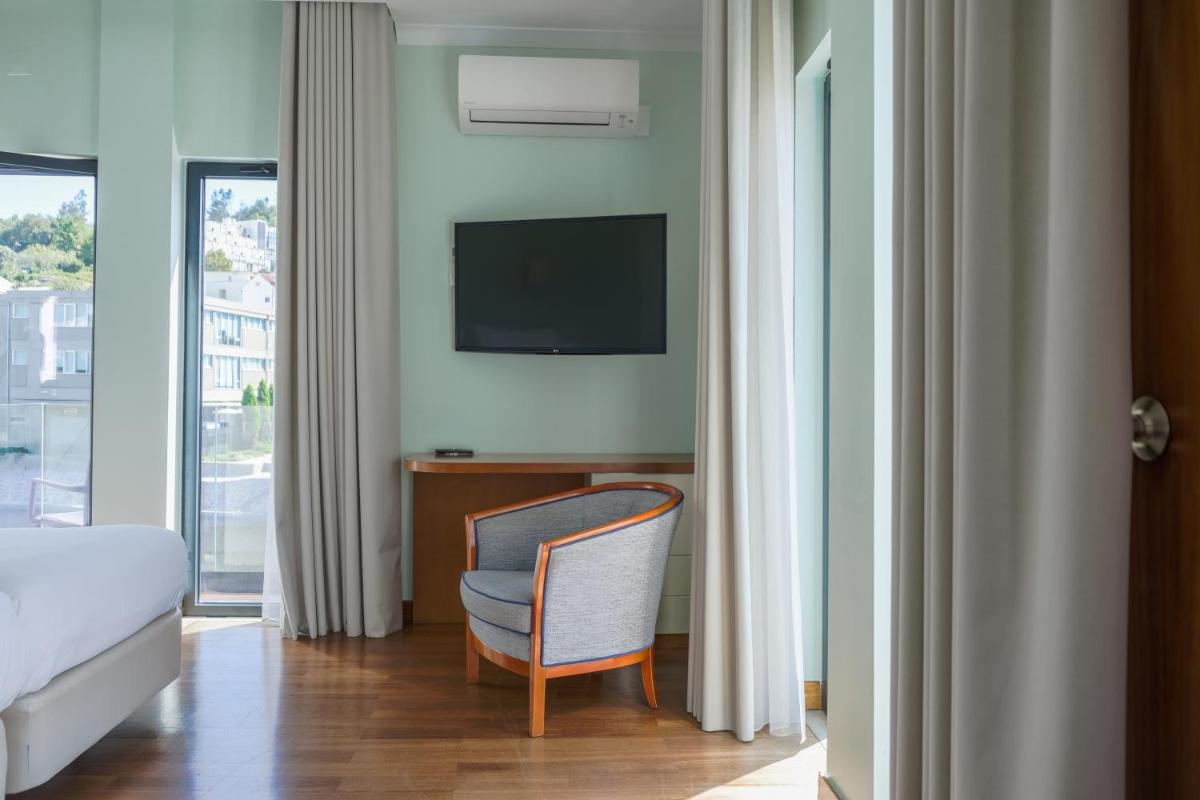 Uma televisão e/ou sistema de entretenimento em Hotel Vouga