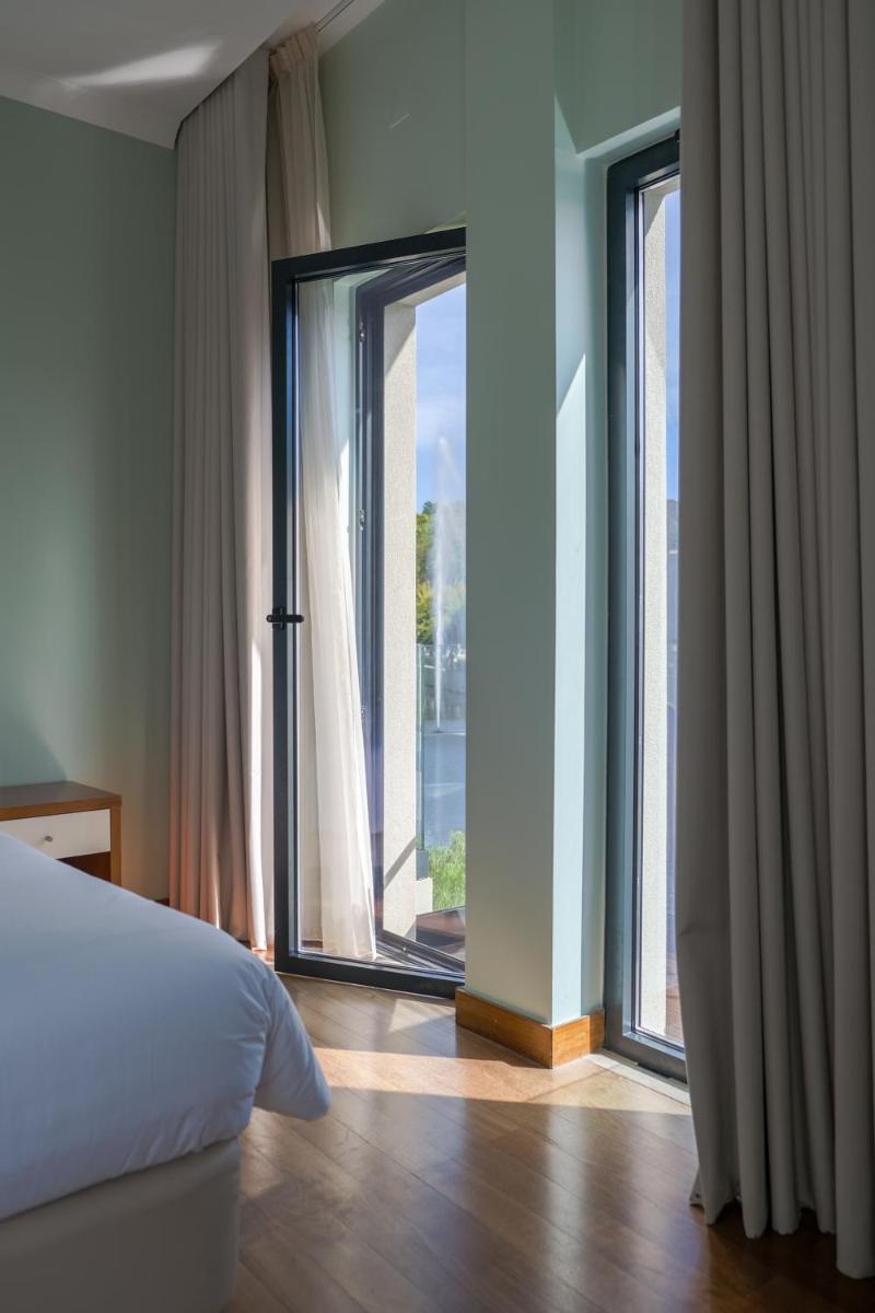Uma cama ou camas num quarto em Hotel Vouga