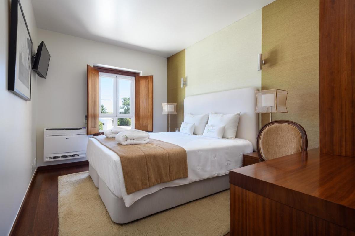 Uma cama ou camas num quarto em Hotel de Charme Casa da Amieira