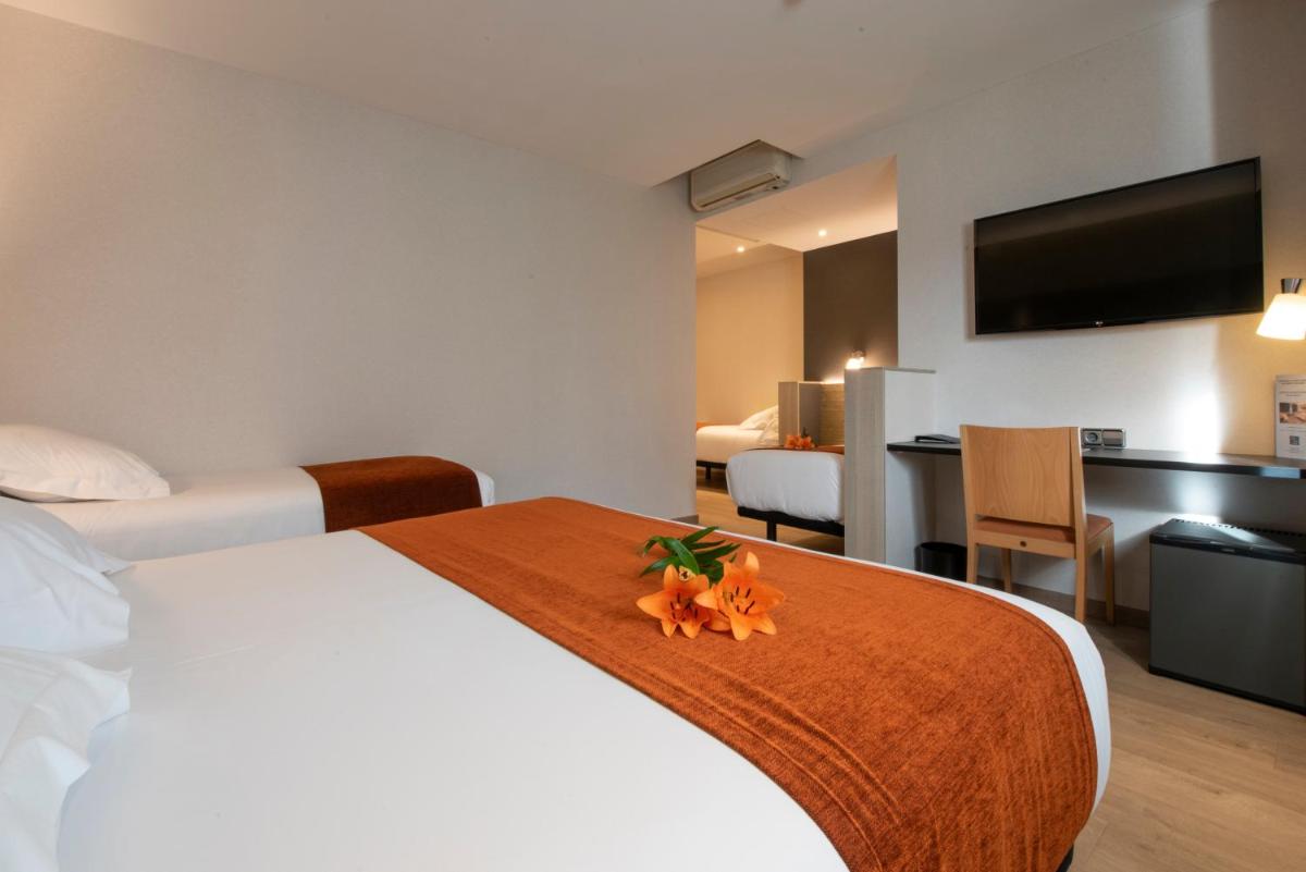 Cama o camas de una habitación en Hotel Avenida