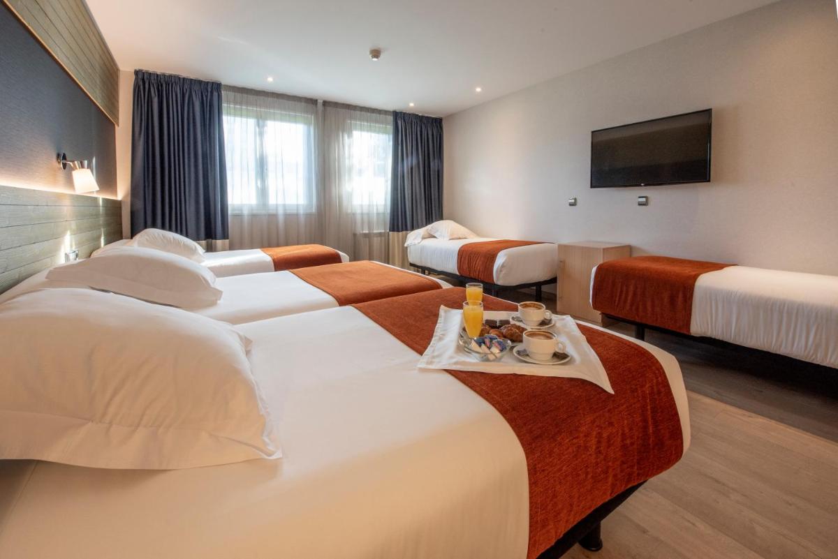 Cama o camas de una habitación en Hotel Avenida