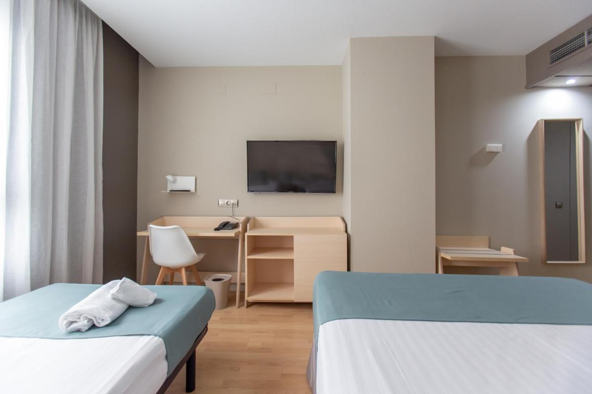 Cama o camas de una habitación en Hotel Olympia Valencia