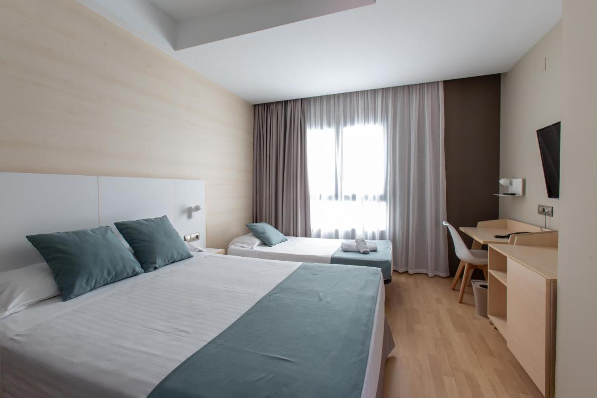 Cama o camas de una habitación en Hotel Olympia Valencia
