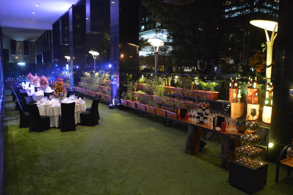 a room with tables and chairs with flowers and candles at Sofitel Mumbai BKC in Mumbai