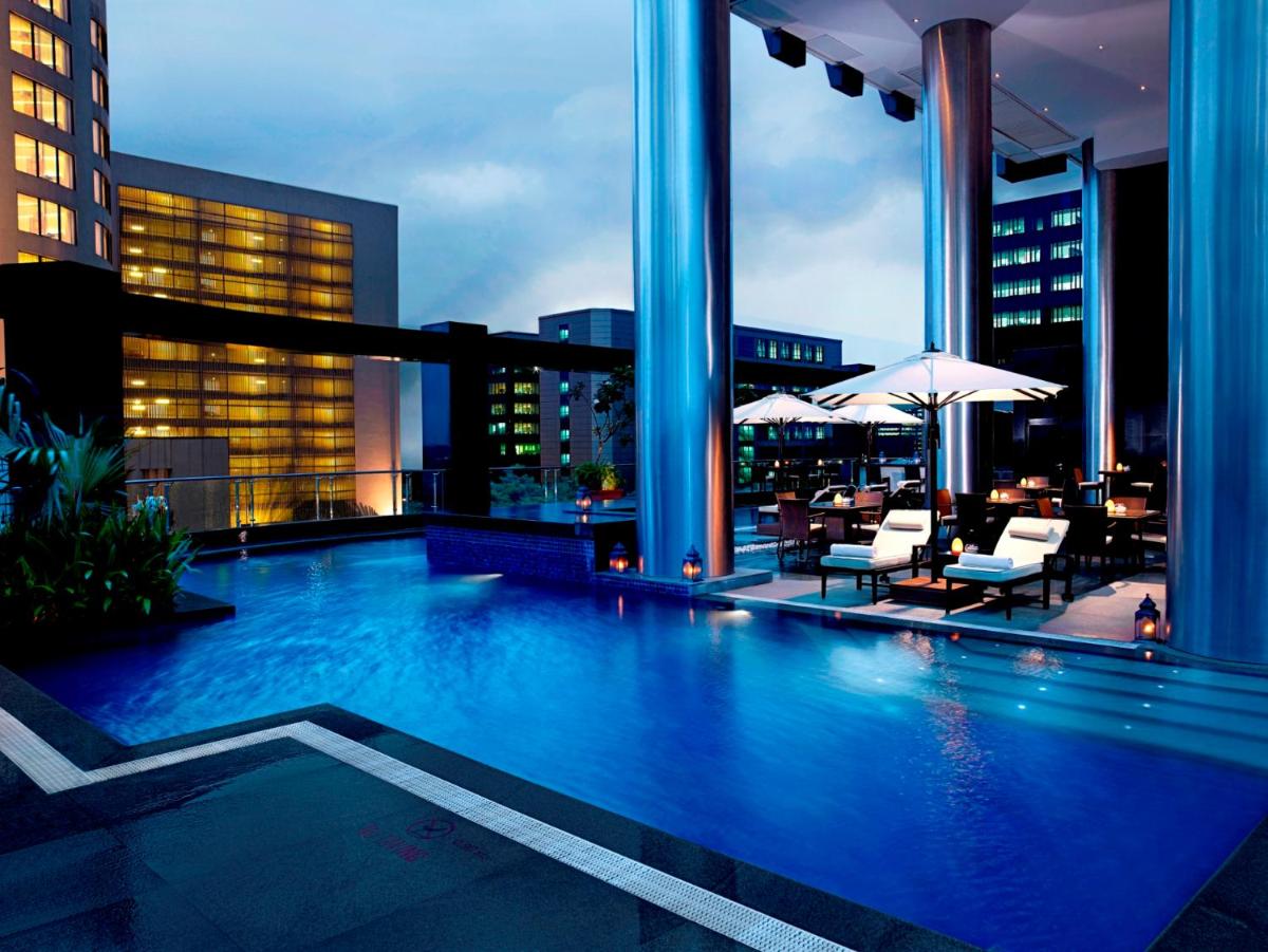 a large swimming pool on the roof of a building at Sofitel Mumbai BKC in Mumbai