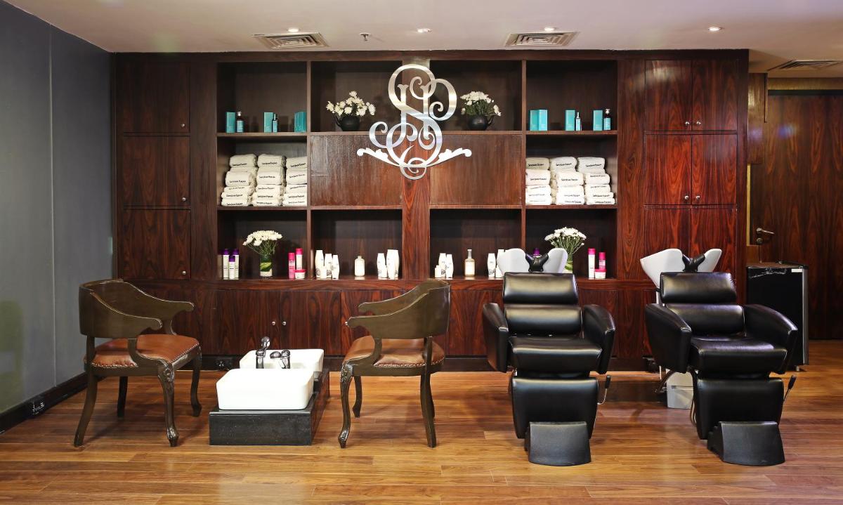 a salon with chairs and a table in a room at Sofitel Mumbai BKC in Mumbai