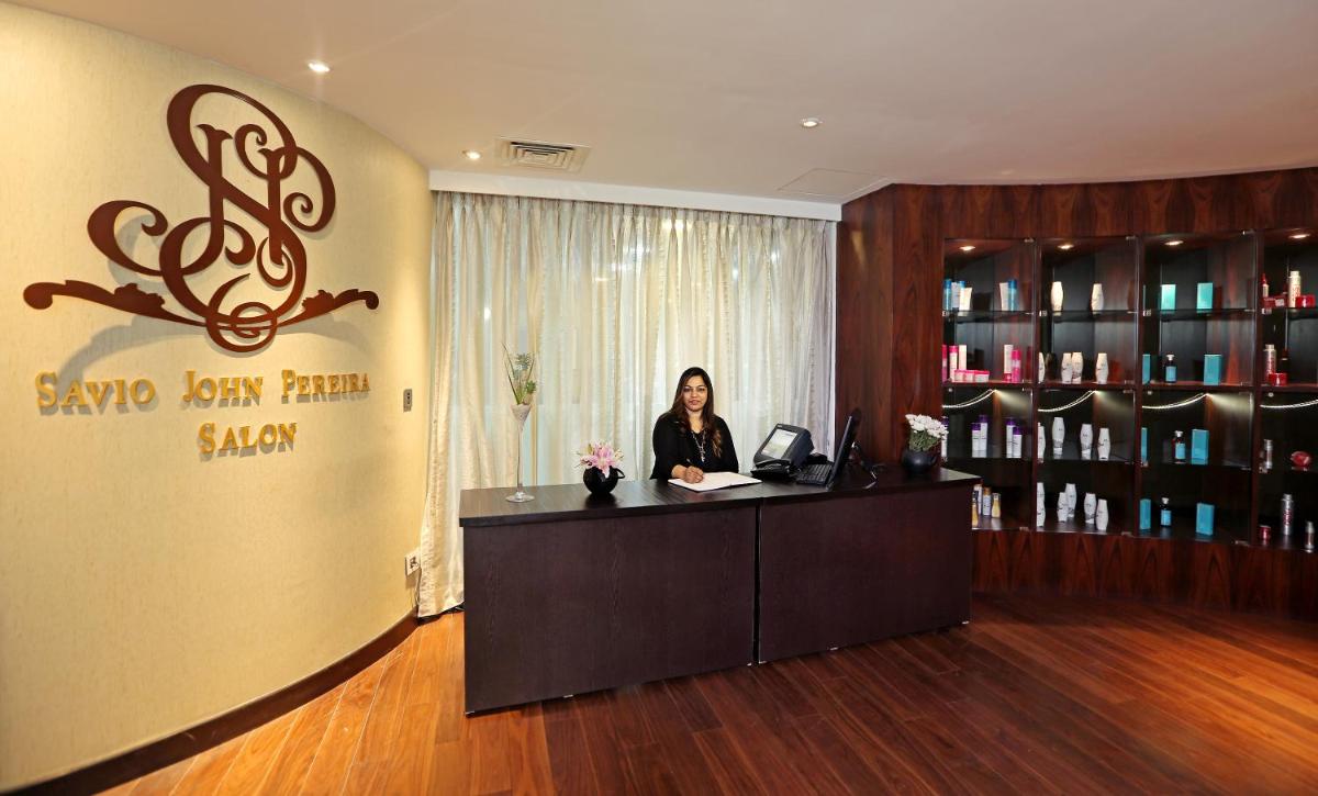 a woman sitting at a reception desk in a salon at Sofitel Mumbai BKC in Mumbai