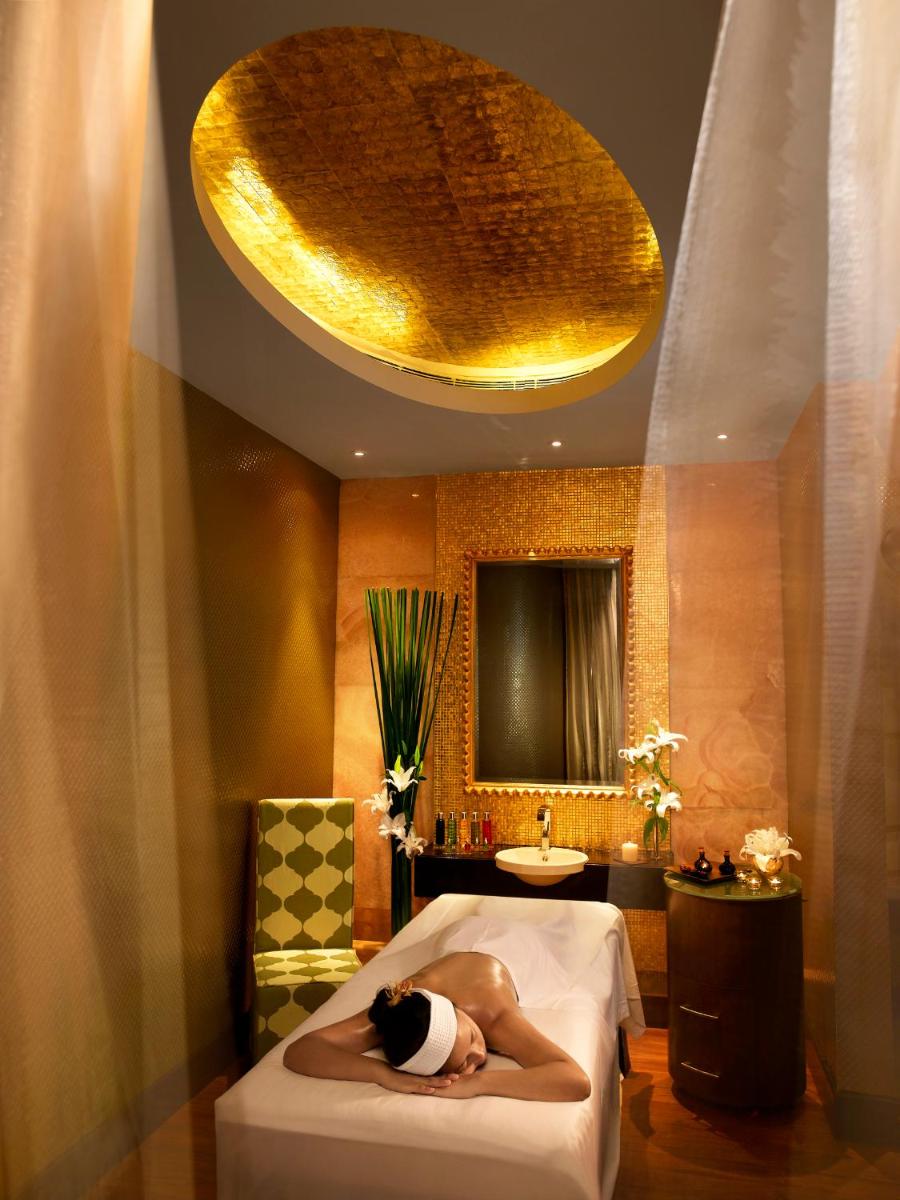 a woman laying on a bed in a bathroom at Sofitel Mumbai BKC in Mumbai