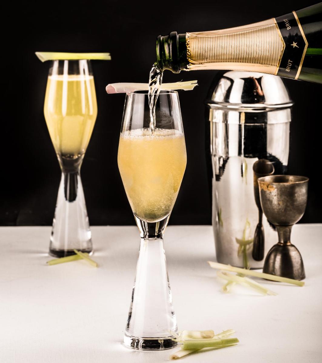 a person is pouring a drink into a glass at Sofitel Mumbai BKC in Mumbai