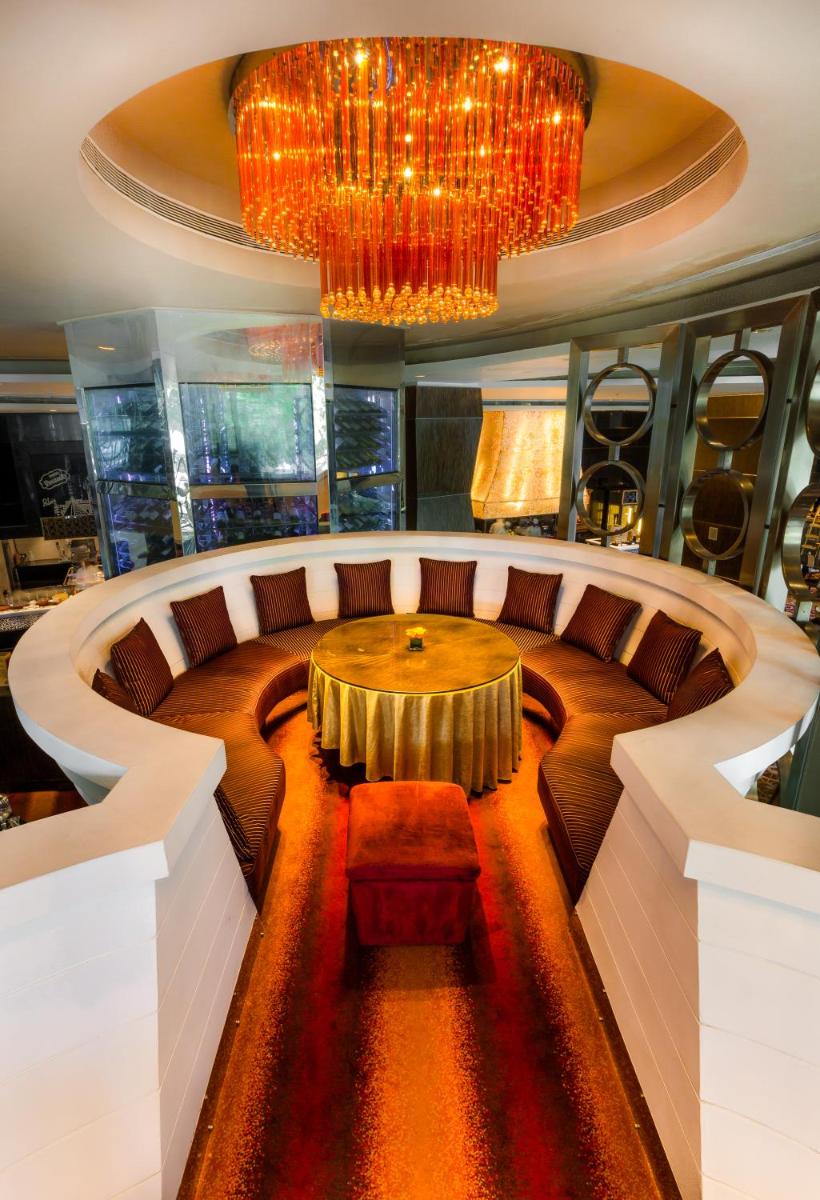 a large room with a table and a couch at Sofitel Mumbai BKC in Mumbai