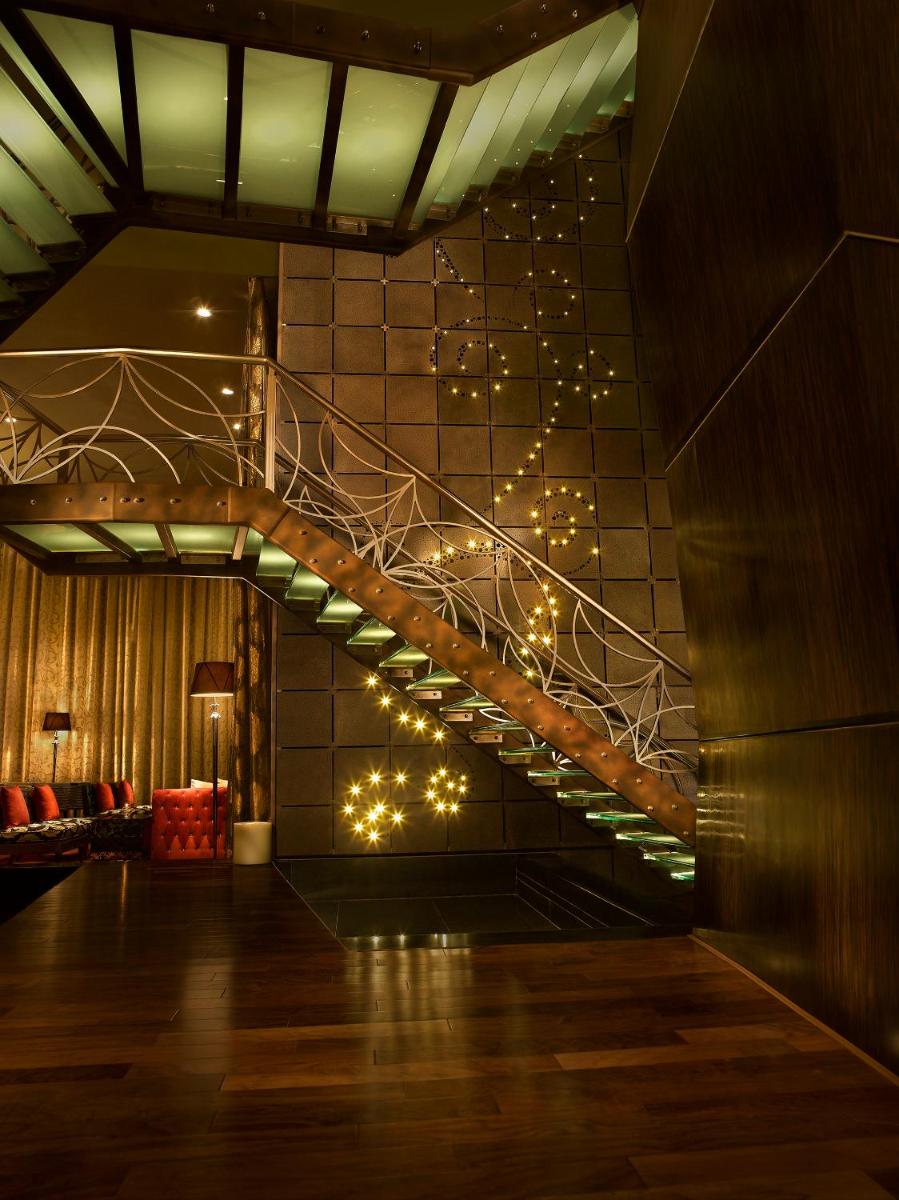 a staircase in a room with lights on the wall at Sofitel Mumbai BKC in Mumbai