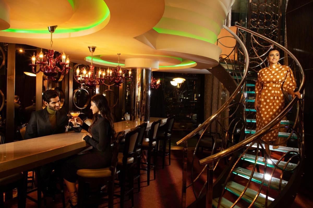 a group of people sitting at a bar at Sofitel Mumbai BKC in Mumbai