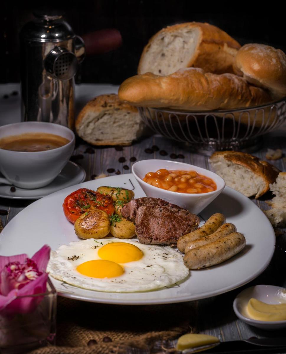 a plate of breakfast food with eggs and bread at Sofitel Mumbai BKC in Mumbai
