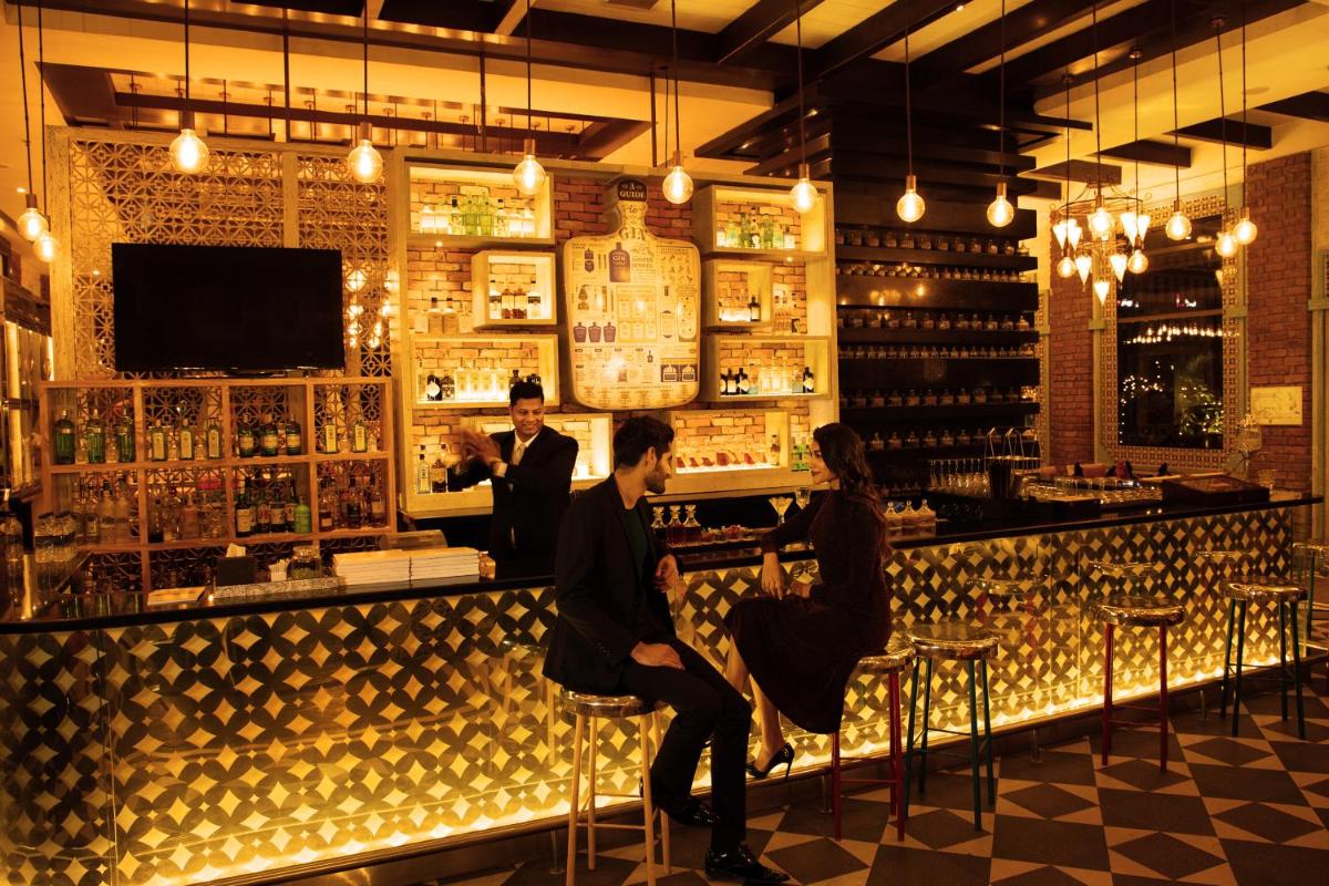 a group of people sitting at a bar at Sofitel Mumbai BKC in Mumbai