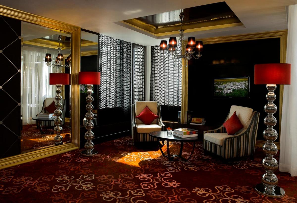 a room with a mirror and two chairs and a table at Sofitel Mumbai BKC in Mumbai
