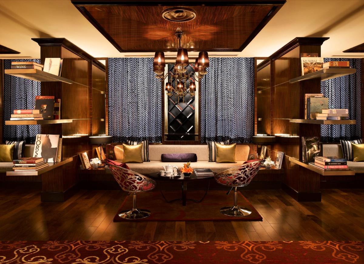 a living room with a couch and a table at Sofitel Mumbai BKC in Mumbai