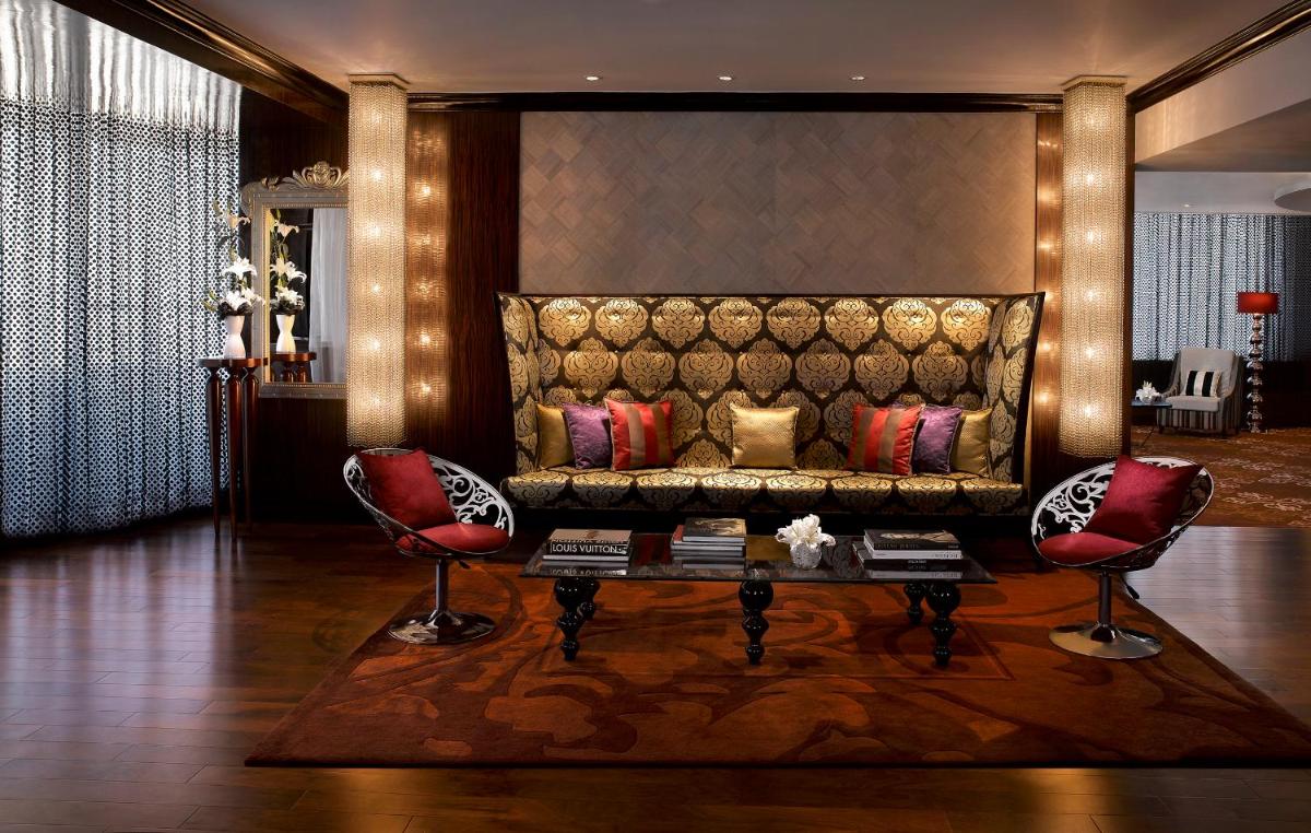 a living room with a couch and two chairs at Sofitel Mumbai BKC in Mumbai