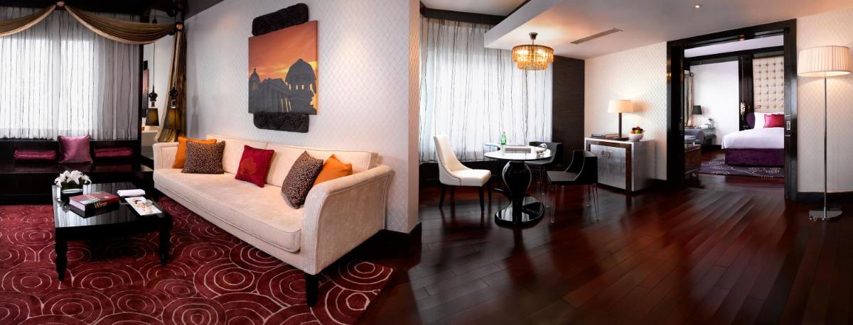 a living room with a couch and a bedroom at Sofitel Mumbai BKC in Mumbai