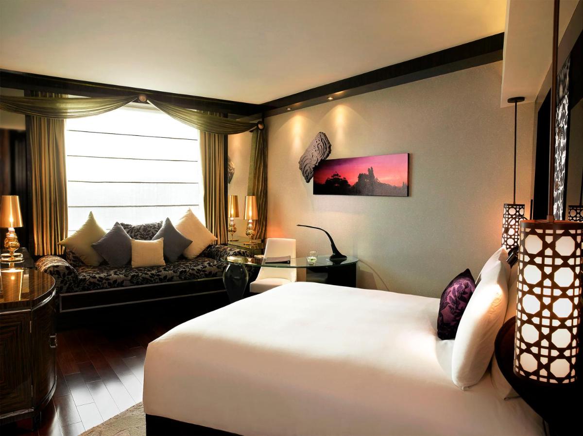 a hotel room with a bed and a couch at Sofitel Mumbai BKC in Mumbai