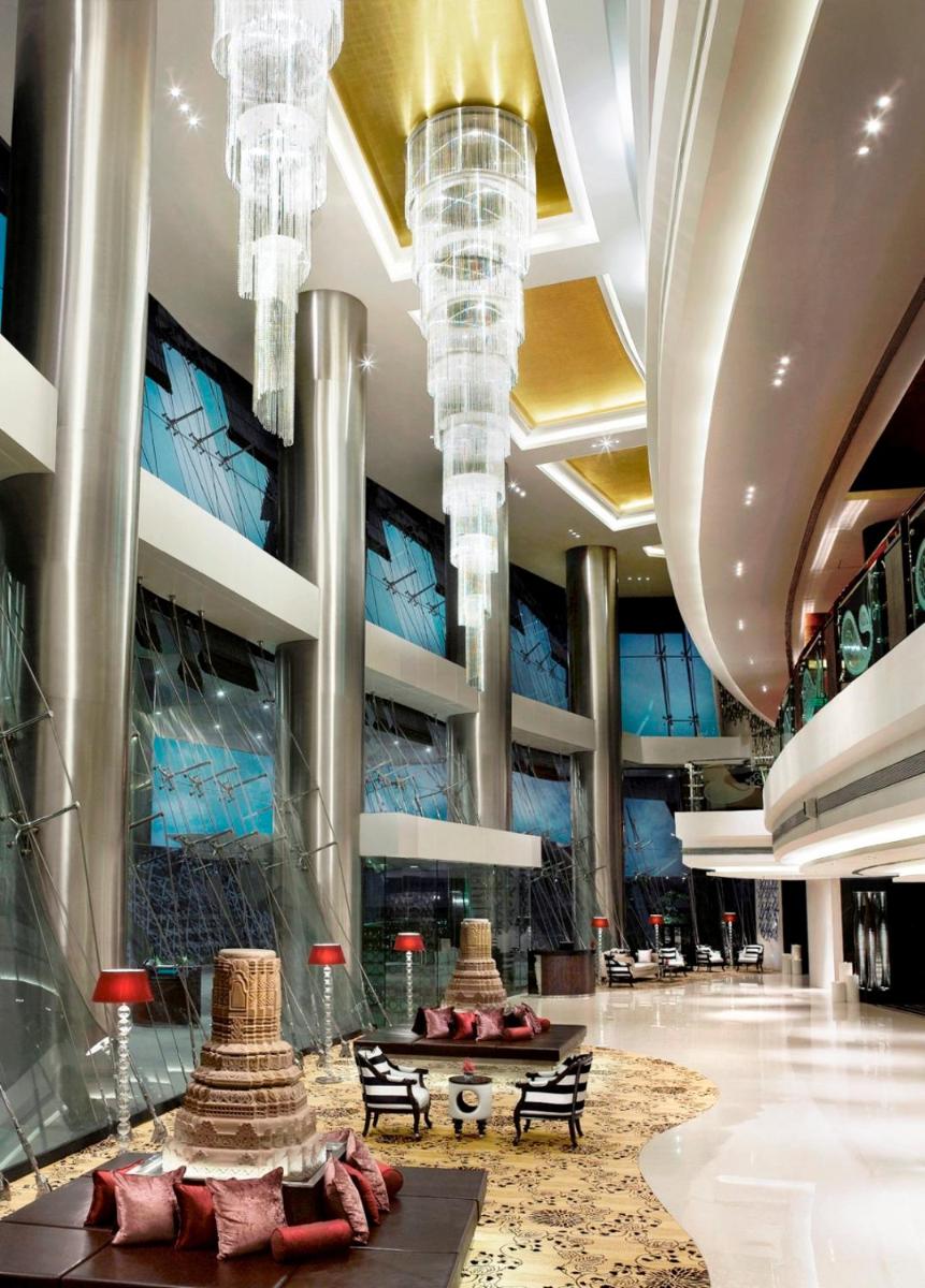 a lobby of a hotel with chandeliers at Sofitel Mumbai BKC in Mumbai