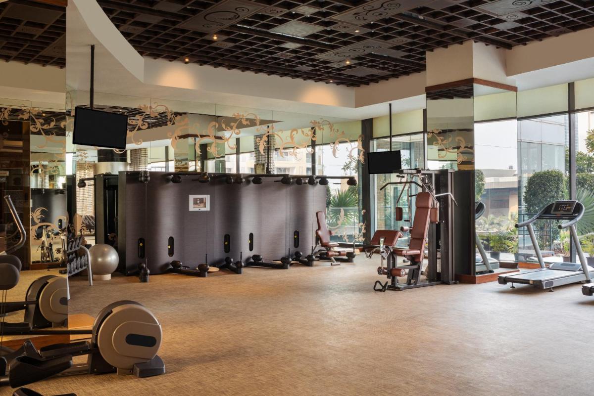 a gym with treadmills and exercise equipment at Sofitel Mumbai BKC in Mumbai