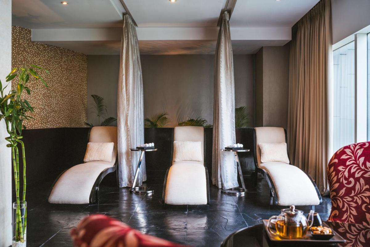 a waiting room with white chairs and a table at Sofitel Mumbai BKC in Mumbai