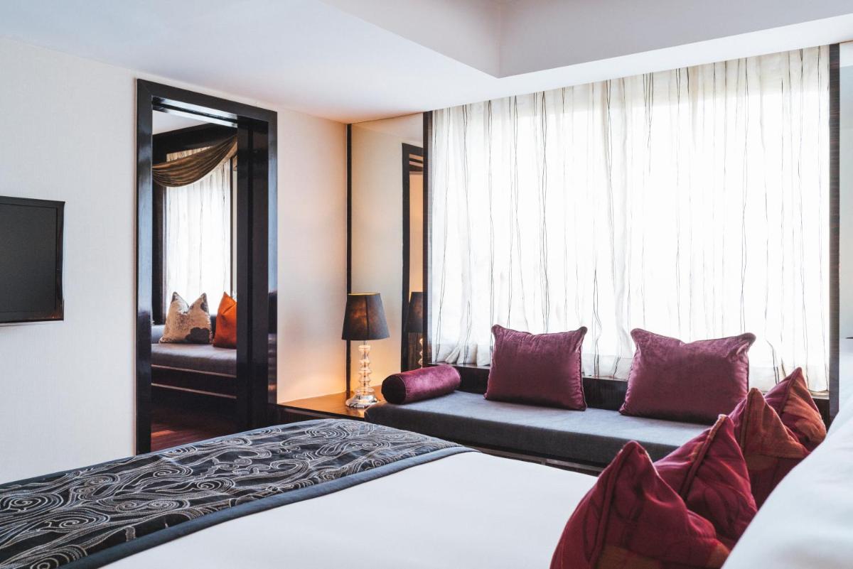 a hotel room with a bed and a couch at Sofitel Mumbai BKC in Mumbai