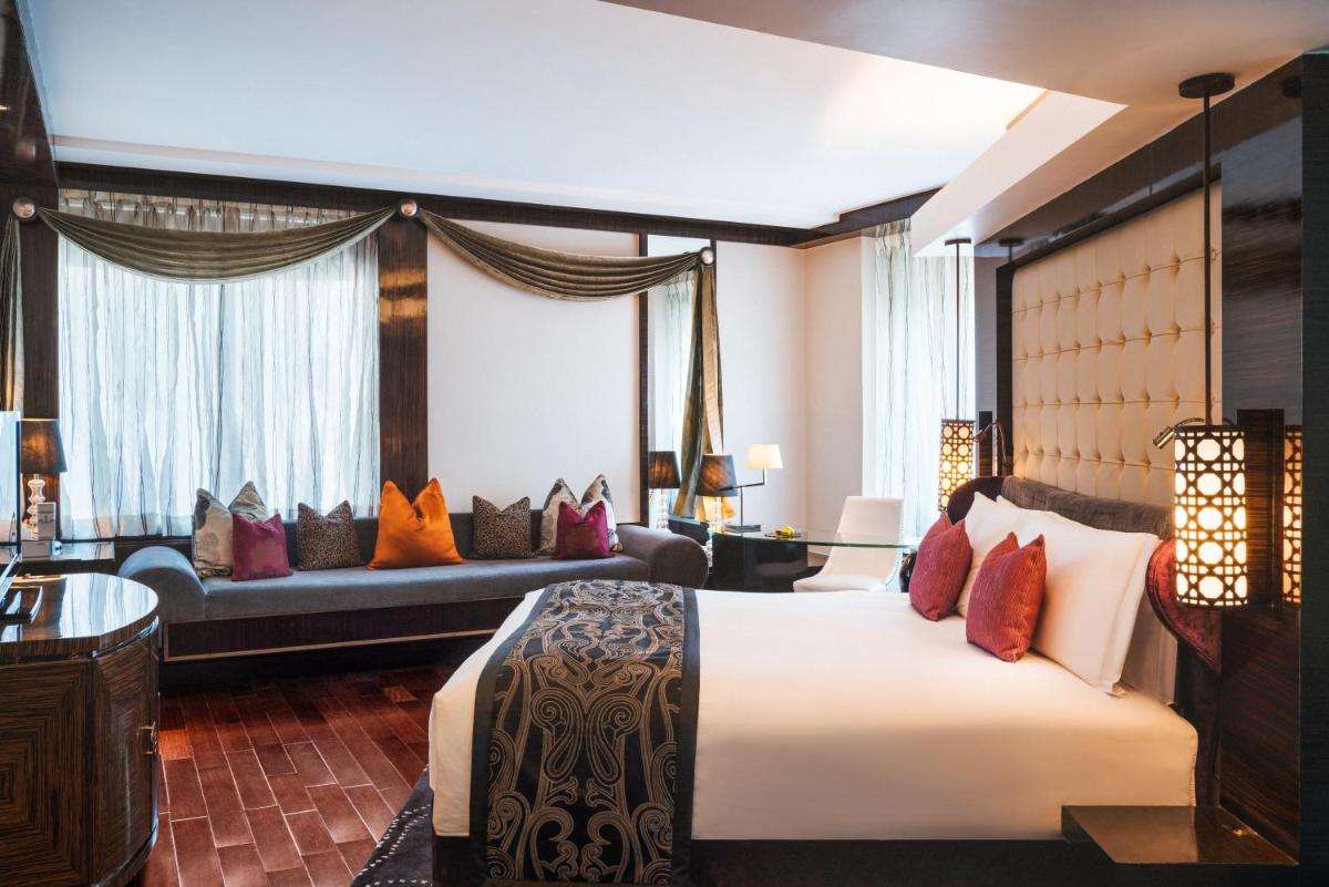 a hotel room with a bed and a couch at Sofitel Mumbai BKC in Mumbai