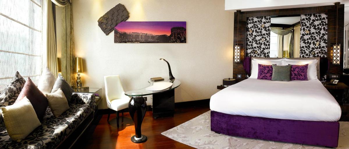 a hotel room with a bed and a couch at Sofitel Mumbai BKC in Mumbai