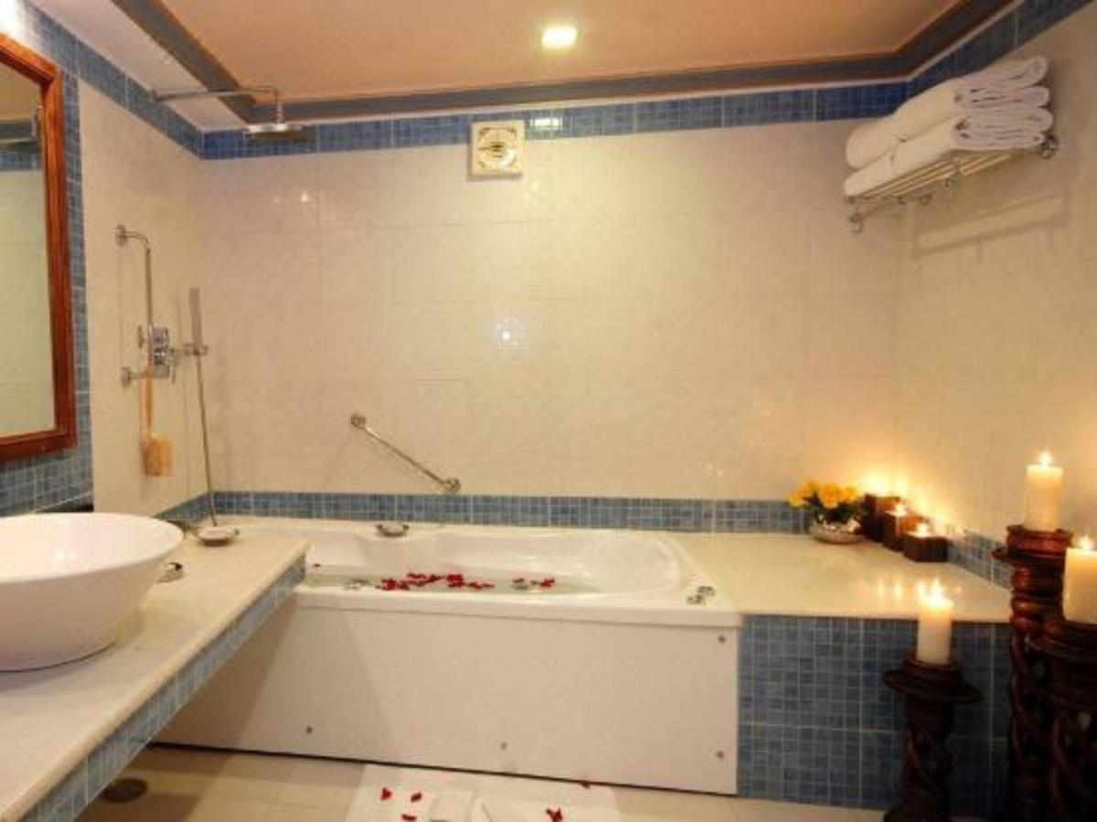 a bathroom with a bath tub and a sink at Shiv Niwas Palace by HRH Group of Hotels in Udaipur