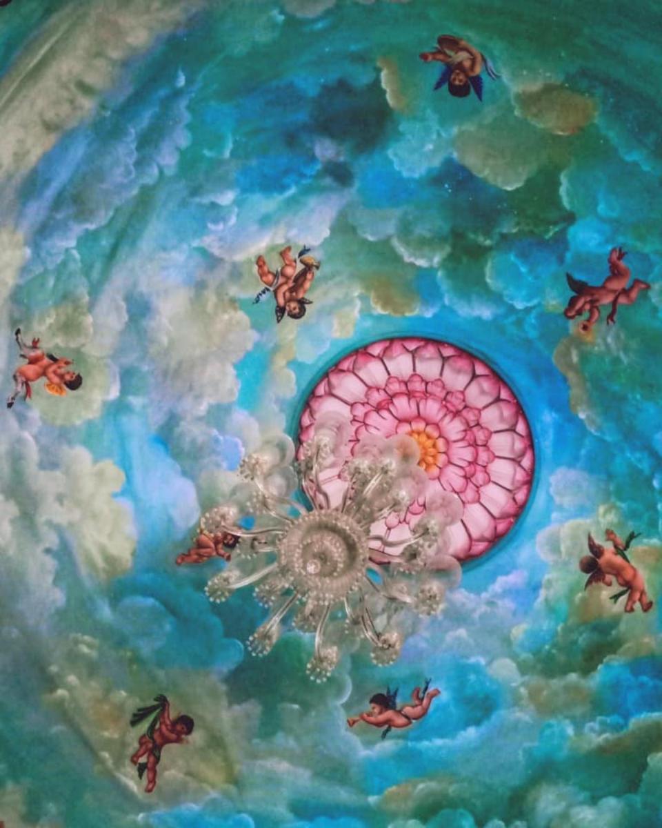 a ceiling painting of a pink organ in the water at Shiv Niwas Palace by HRH Group of Hotels in Udaipur