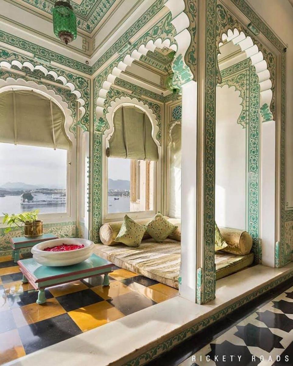 a room with a couch and a table in a building at Shiv Niwas Palace by HRH Group of Hotels in Udaipur