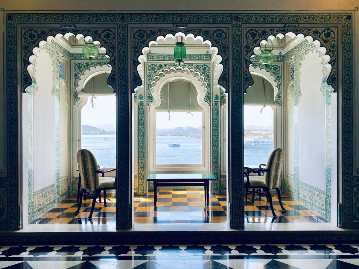 a room with two chairs and a table and two windows at Shiv Niwas Palace by HRH Group of Hotels in Udaipur