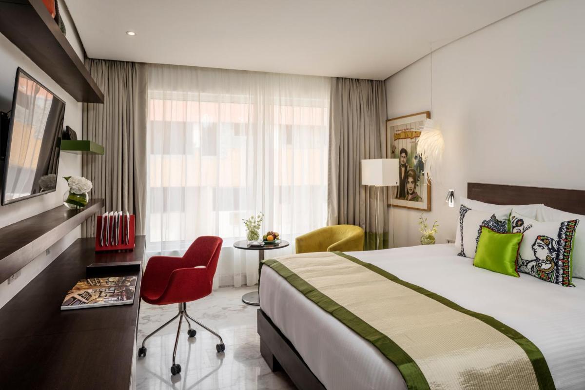 a hotel room with a large bed and a desk at The Park Chennai in Chennai a hotel room with a large bed and a desk at The Park Chennai in Chennai