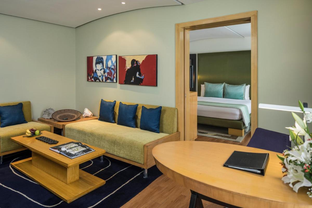 a living room with a couch and a bed at The Park Chennai in Chennai a living room with a couch and a bed at The Park Chennai in Chennai