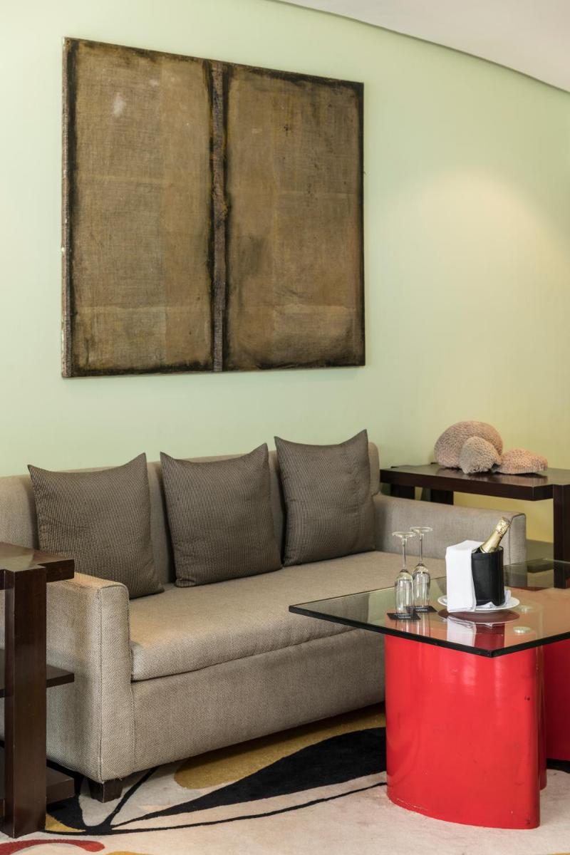 a living room with a couch and a table at The Park Chennai in Chennai a living room with a couch and a table at The Park Chennai in Chennai