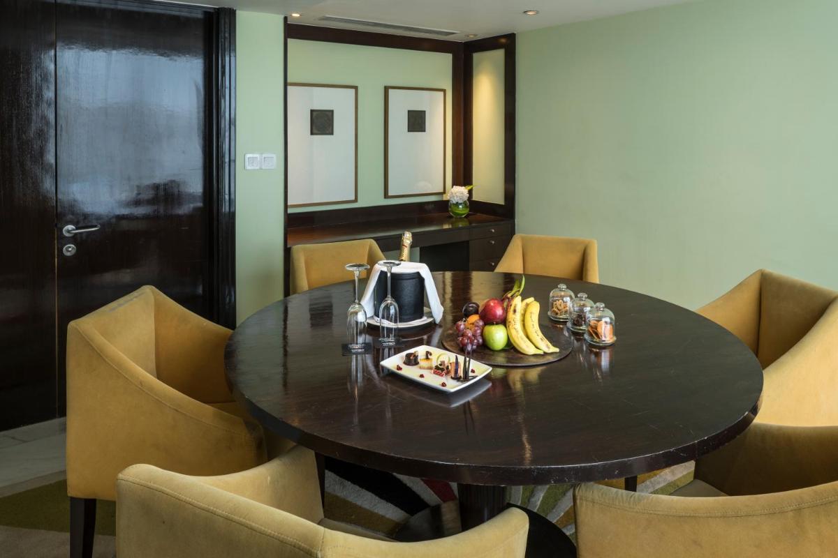 a table with a tea kettle and fruit on it at The Park Chennai in Chennai a table with a tea kettle and fruit on it at The Park Chennai in Chennai