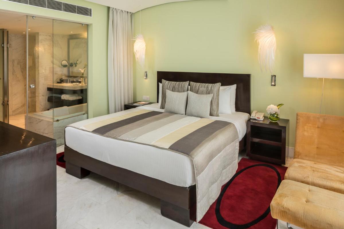 a bedroom with a large bed and a bathroom at The Park Chennai in Chennai a bedroom with a large bed and a bathroom at The Park Chennai in Chennai
