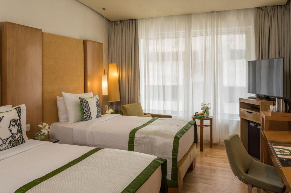 a hotel room with two beds and a flat screen tv at The Park Chennai in Chennai a hotel room with two beds and a flat screen tv at The Park Chennai in Chennai