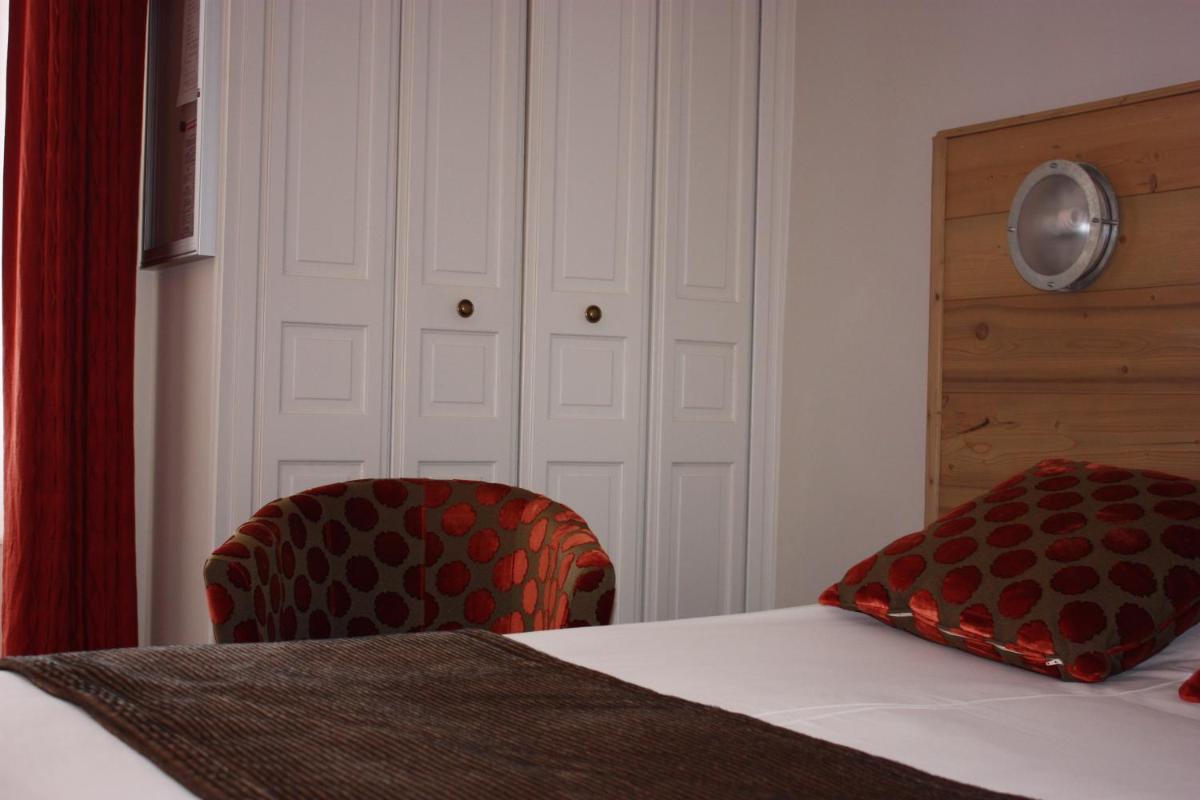 Un ou plusieurs lits dans un hébergement de l'établissement Hotel le Chalet