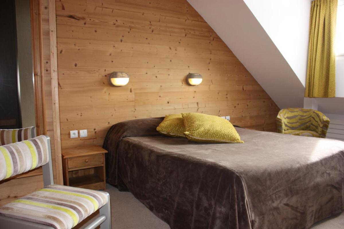 Un ou plusieurs lits dans un hébergement de l'établissement Hotel le Chalet